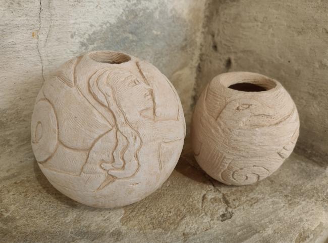 Two clay pots in the corner of a church