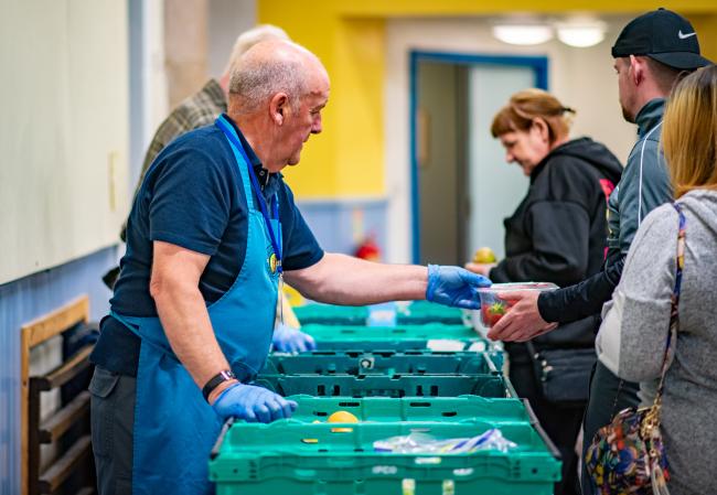 Volunteers hand out food
