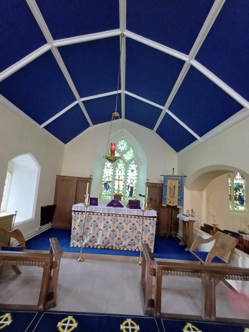 Inside a church with a blue ceiling