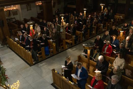 The pews of a church occupied by people singing