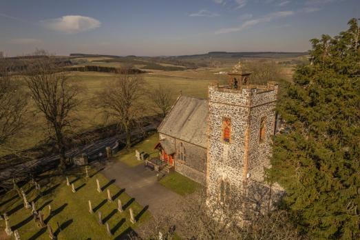 A church set in a wide landscape
