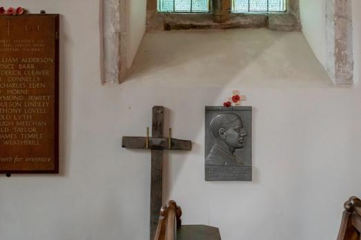 A cross and a plaque inside a church